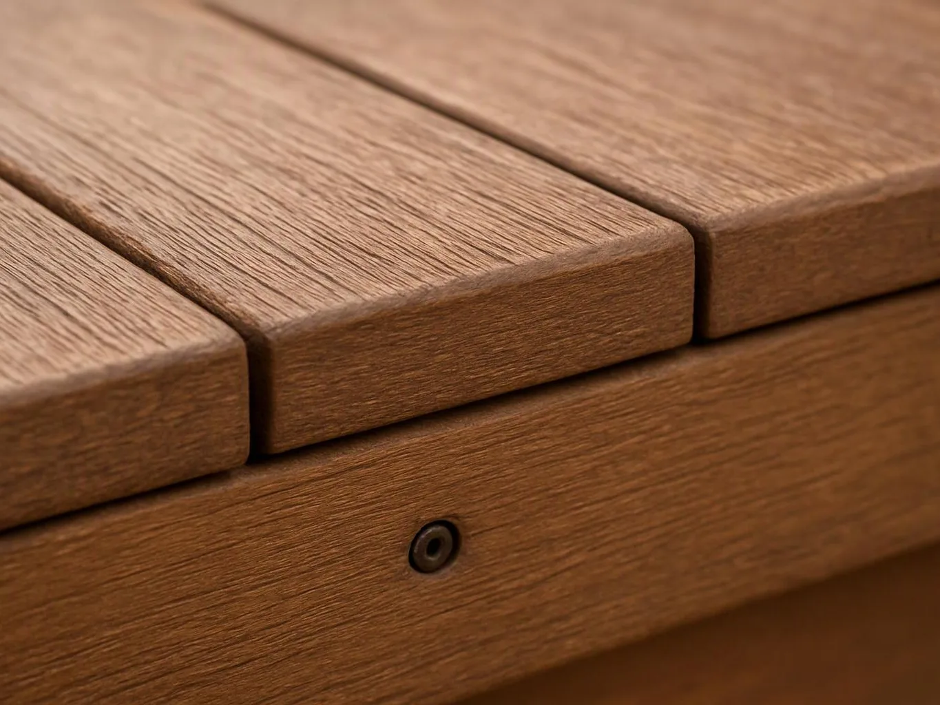 Close-up of a wooden surface with slatted boards and a small metal fastener visible below